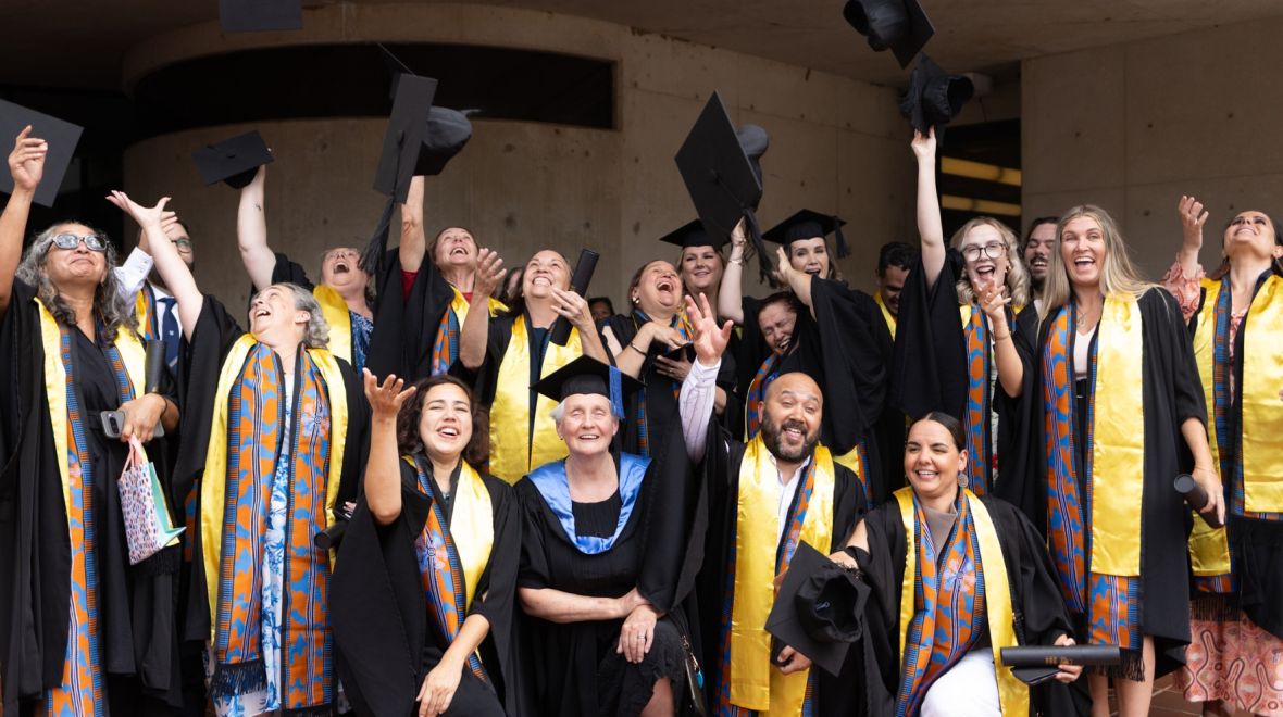 Graduates of the APS First Nations Graduate Certificate of Management Program celebrate their February 2026 graduation, throwing their caps in the air.